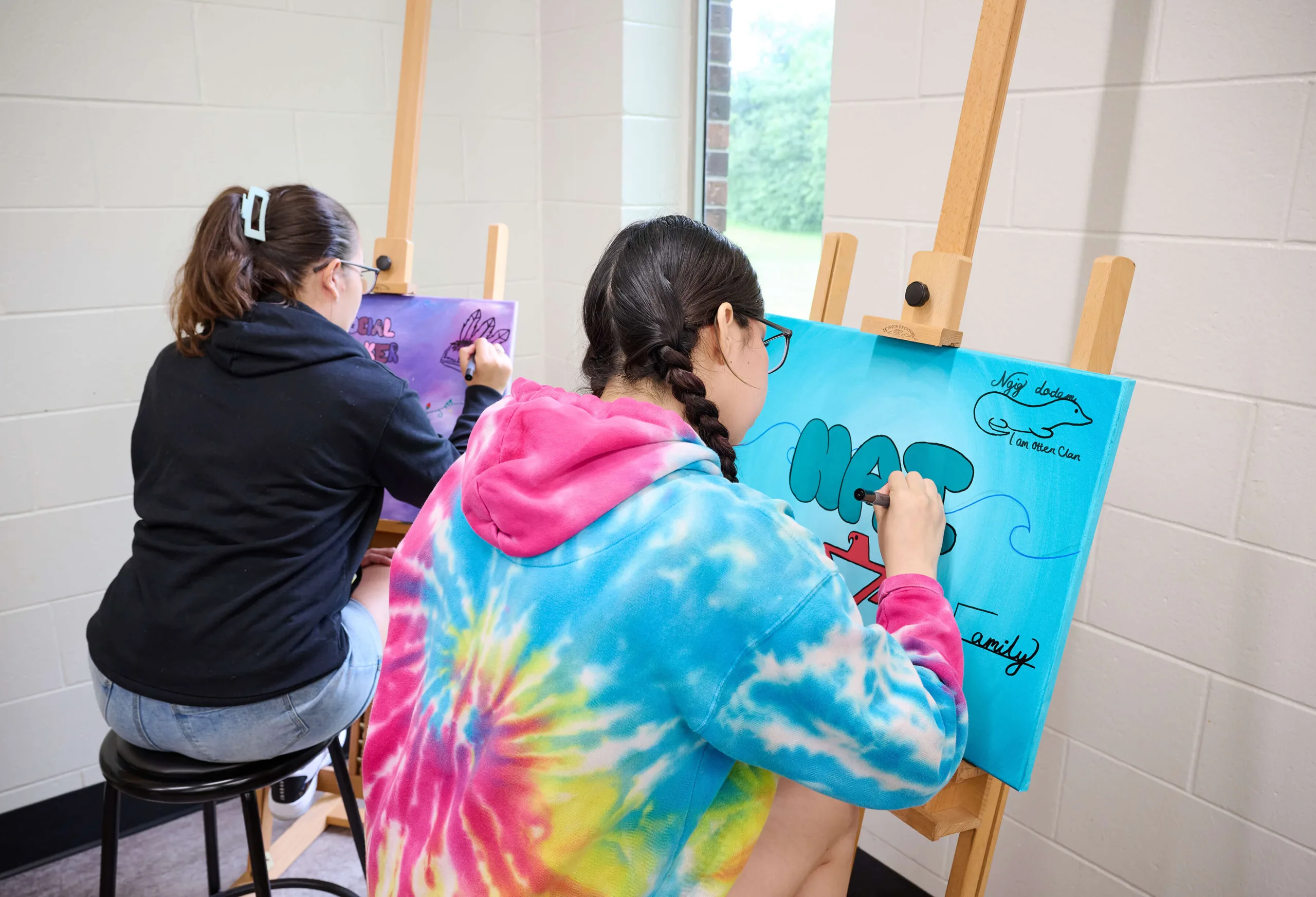Young women are drawing, having an art class