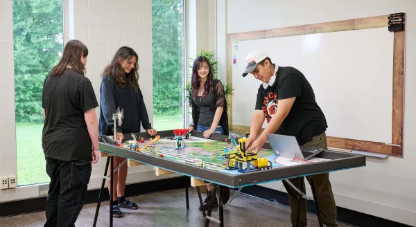 Students exploring the technical aspects of a construction job by building equipment.