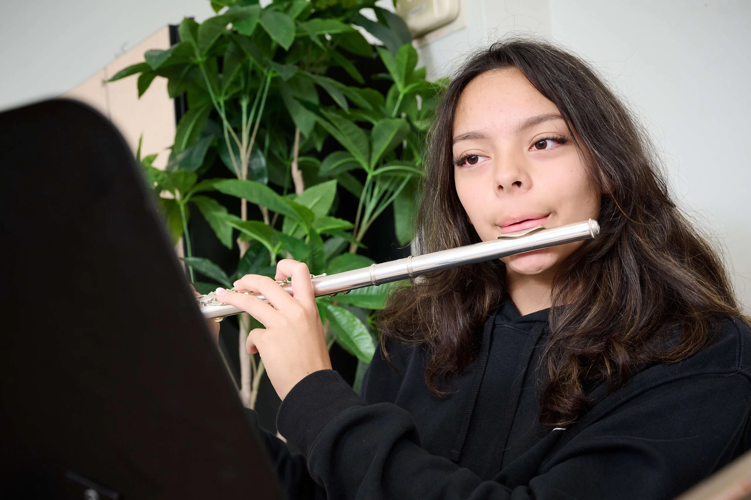 Young women is playing on a flute
