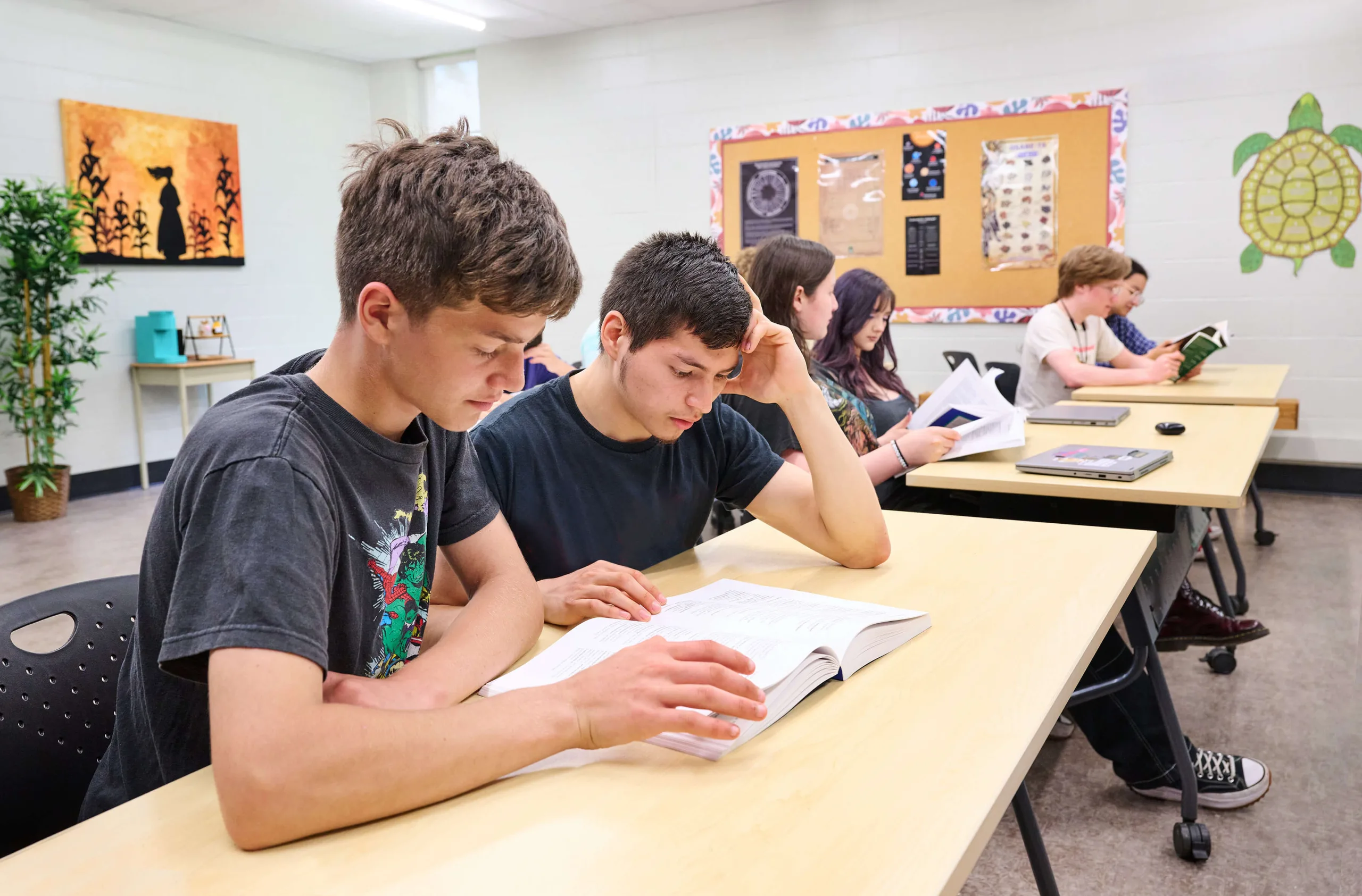 Students reading a book, having a business class